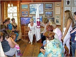 Alicia Rodriges tells about value of the Banner of Peace to visitors of the Roerich's museum of Uimon valley